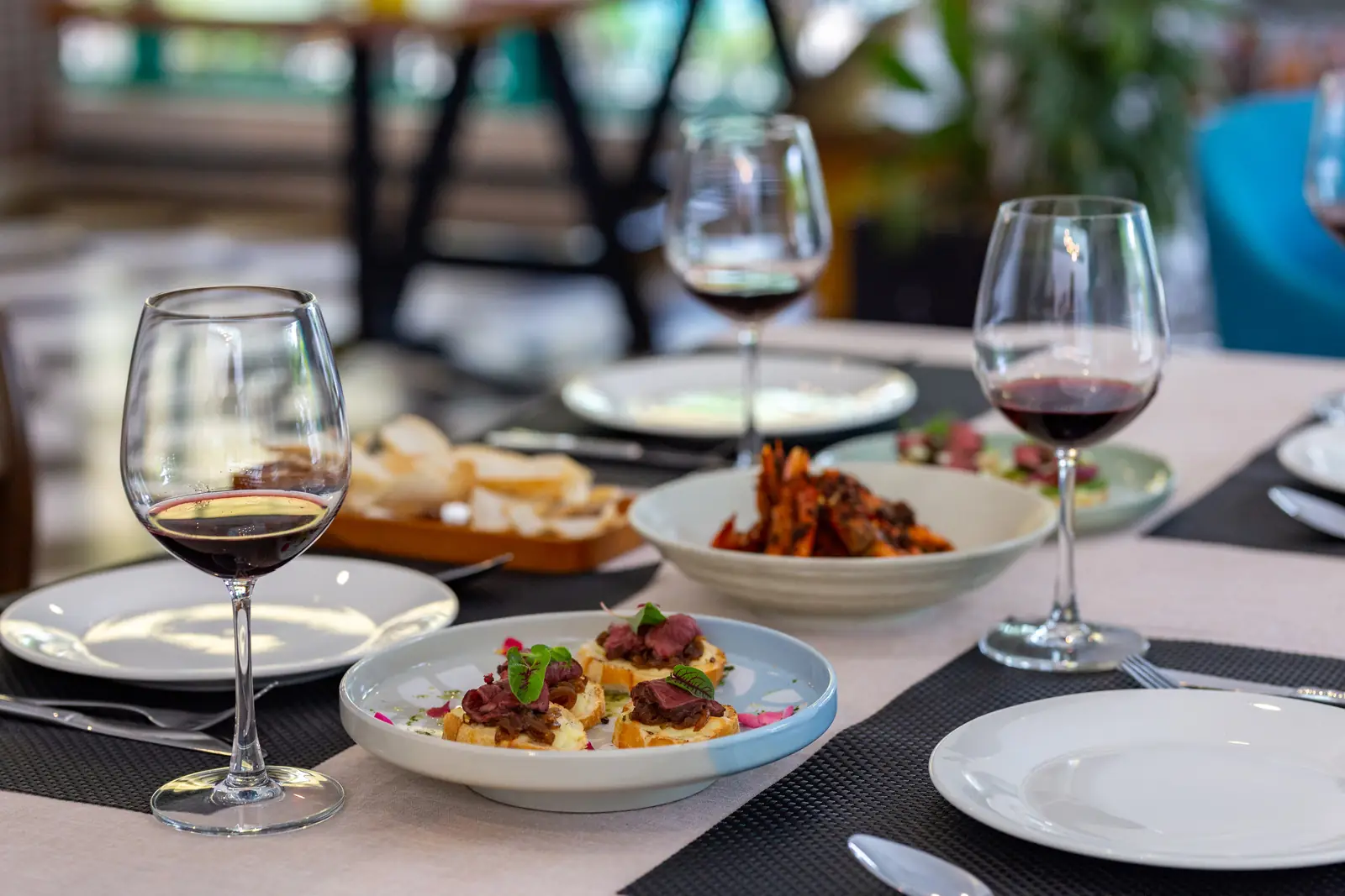 Red wine and plated food at an evening function